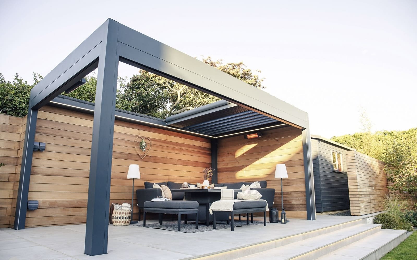 Pergola shown from the side at dusk with louvres overhead